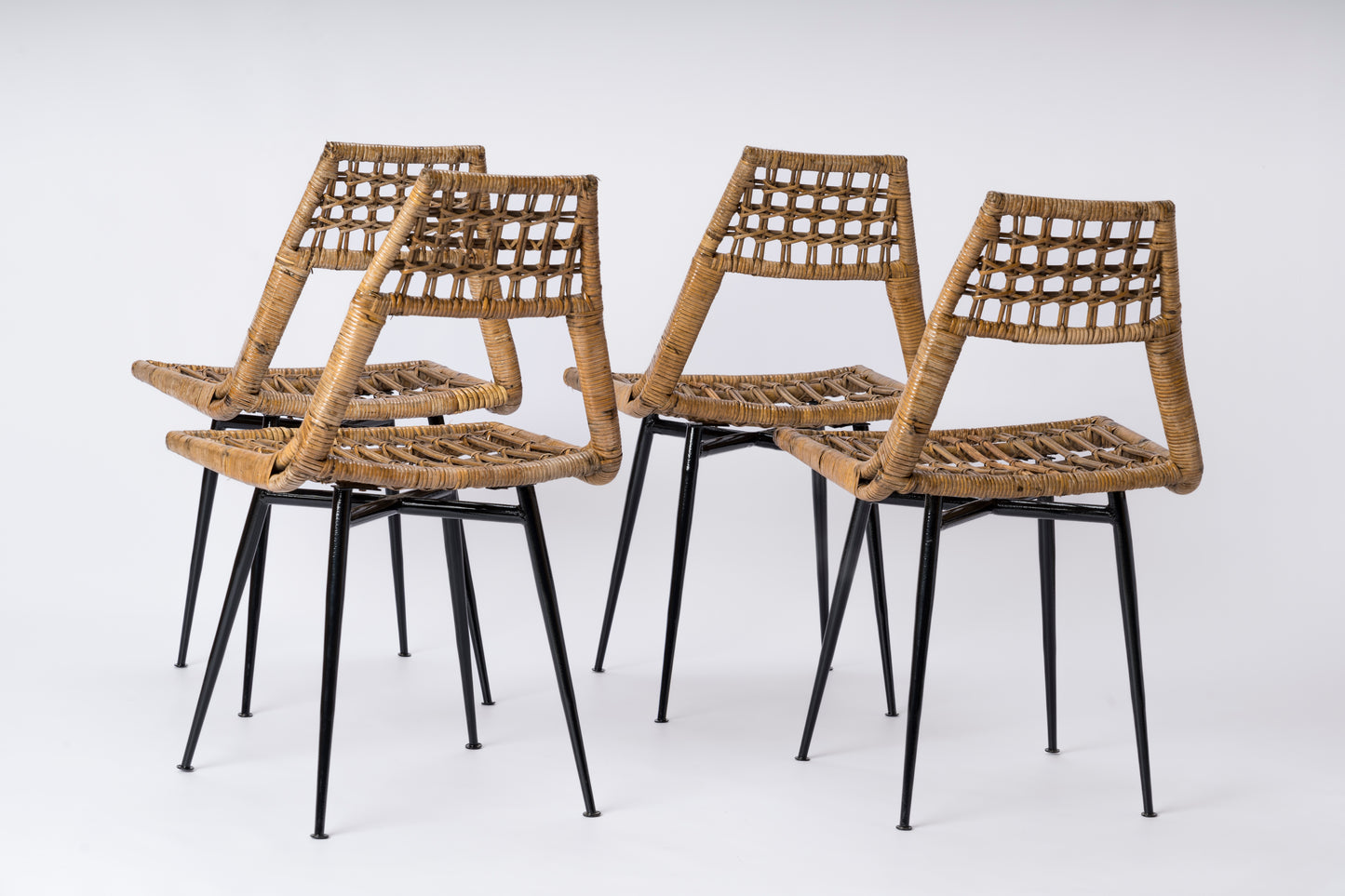 Set of four Rattan Basket Chairs by Lucien Carrier