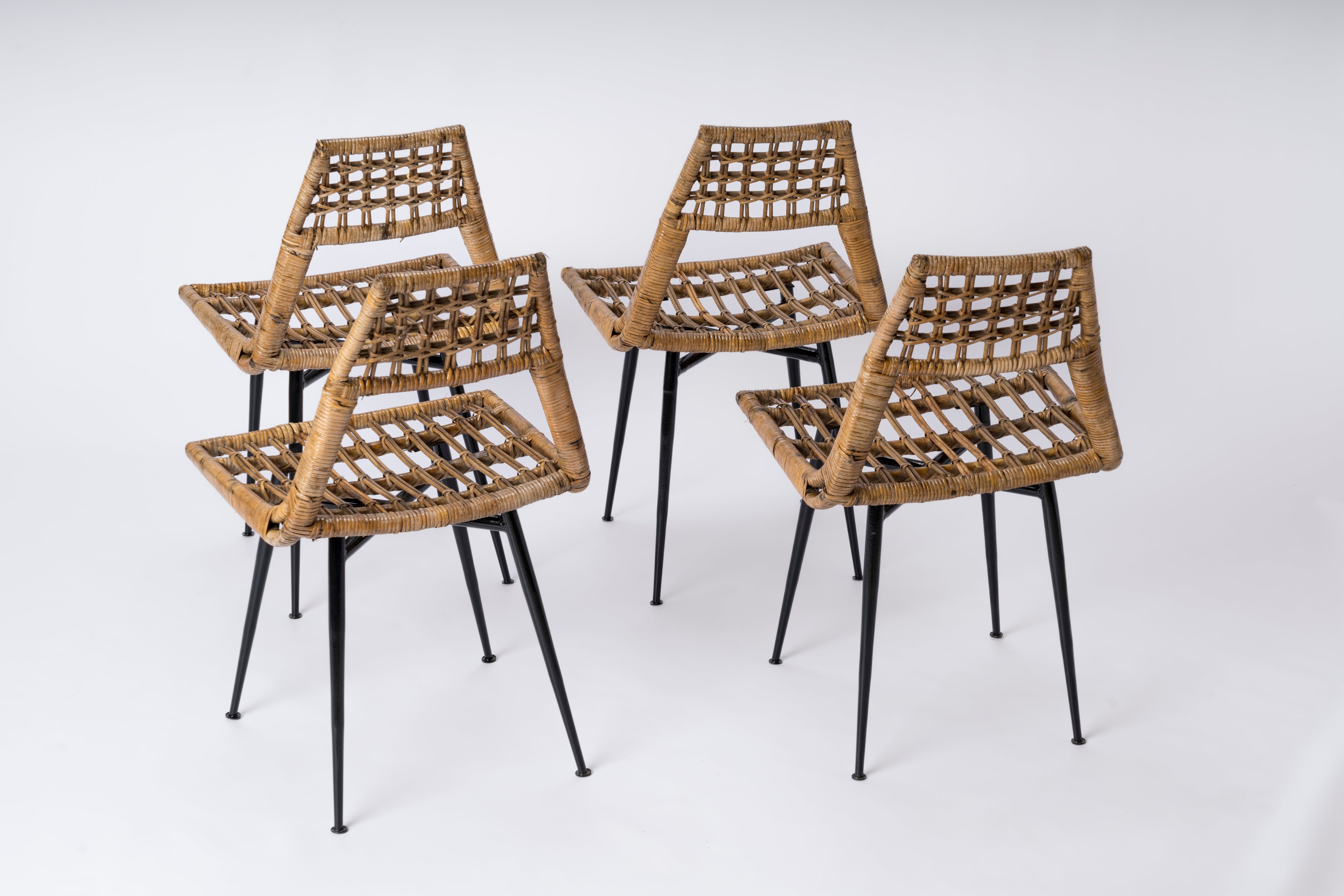 Set of four Rattan Basket Chairs by Lucien Carrier